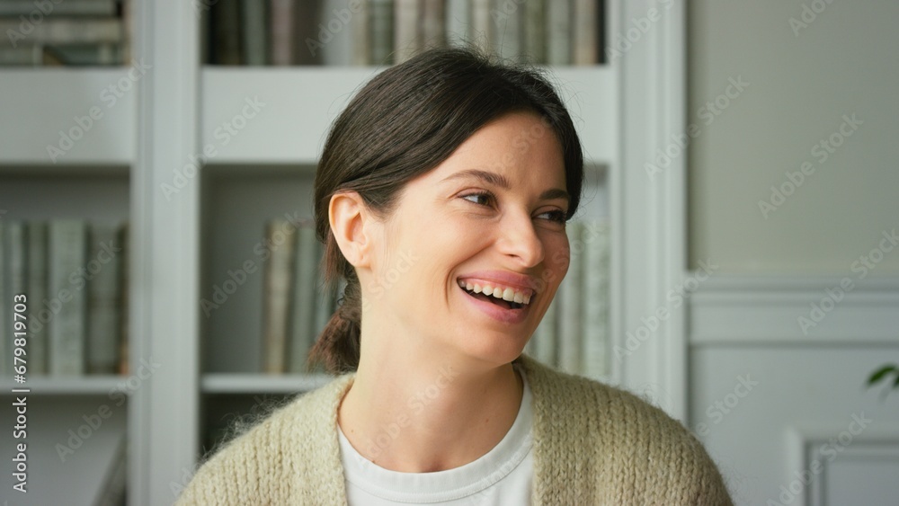 Portrait of a beautiful smiling confident young woman posing alone at home in office. European woman standing indoor smiling looking at camera. Happy casual lady with pretty face. Close up