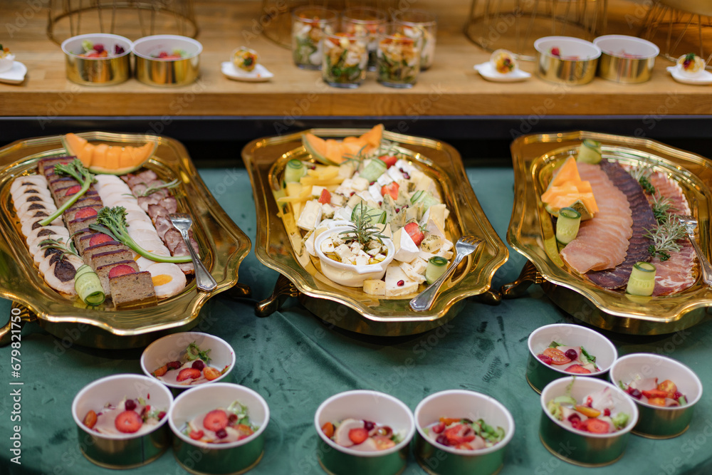 Assortment of various light snacks of meat, cheese, fish on buffet table. Enjoying taste. 