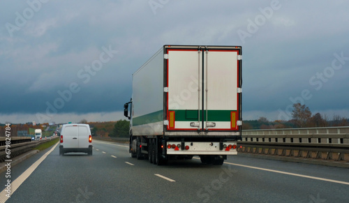 A truck in motion on the intercity highway motorway with two lanes