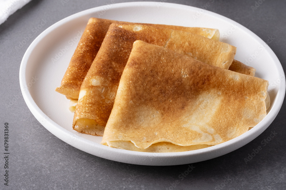 Plate with thin pancakes on table Plate with thin pancakes on table