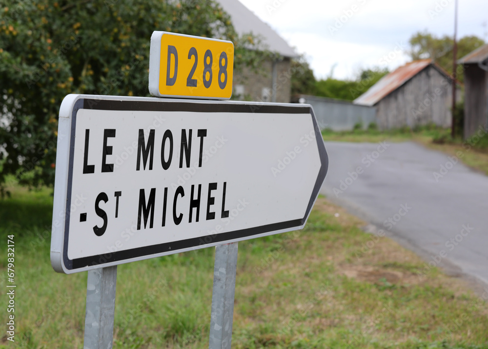 sign with directions to Mont Saint Michel where there is the Ancient Abbey on the hill in France