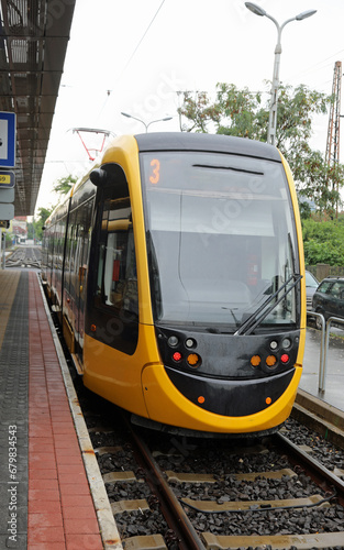 yellow tram number 3 stopped at the terminus on the tracks without people
