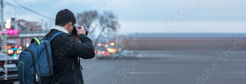 traveler man holding camera in street