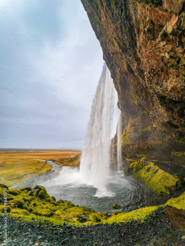 view from the side of the waterfall; Seljalandfoss on the ring road, Iceland
