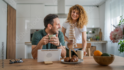 happy couple man and woman husband and wife morning routine use tablet photo