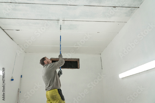 Skilled Craftsman Painting a Room in Fresh Overalls with Precision and Care.