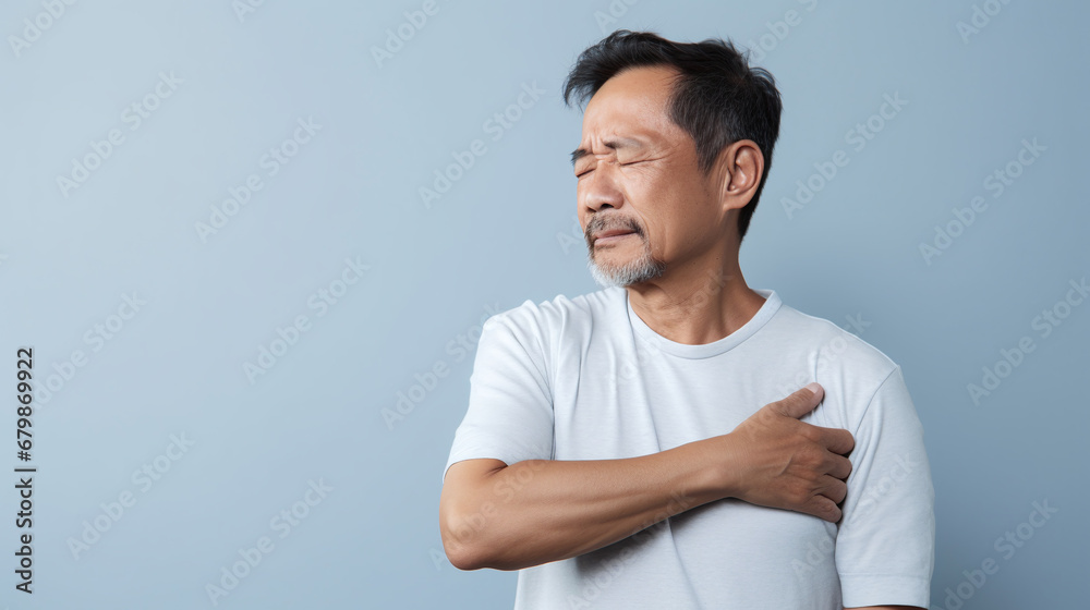 diseases and illnesses - man with face distorted in pain holds one hand at his neck,shoulder or upper arm diseases and illnesses - man with face distorted in pain holds one hand at his neck,shoulder or upper arm