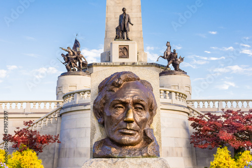 Morning at  Abraham's Lincoln's tomb in Springfield, Illinois. Close-up of Lincoln's sculpted head with tomb in background, sunshine, fall colors. photo