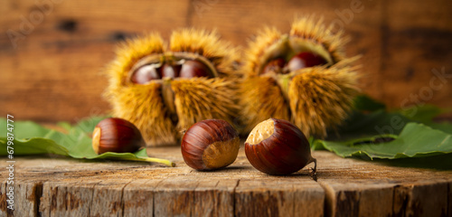 Sweet Chestnuts - Castanea sativa on an old wooden table photo