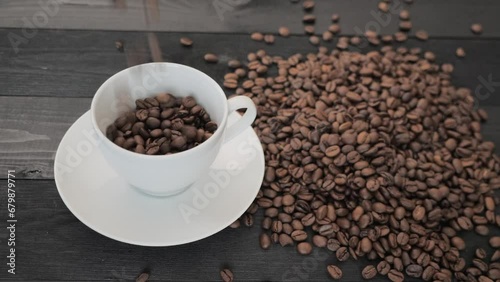 Coffee Beans falling down in a coffee cup