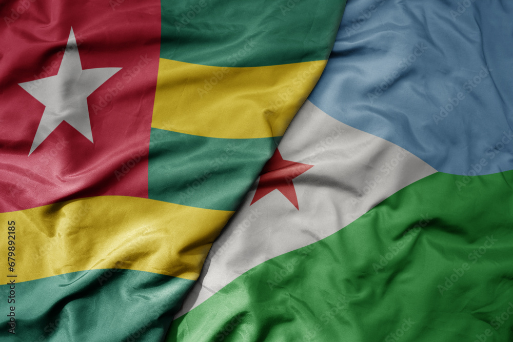 big waving national colorful flag of djibouti and national flag of togo .
