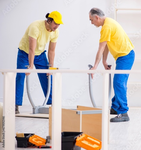Two contractors carpenters working indoors
