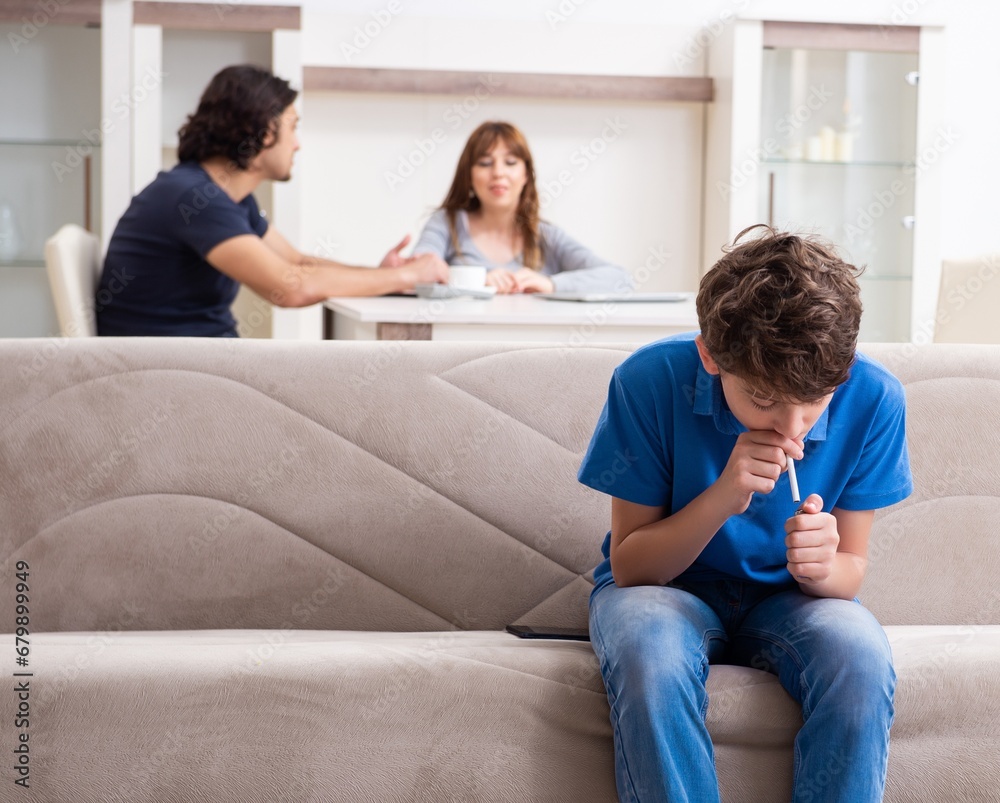 Concept of underage smoking with young boy and family Concept of underage smoking with young boy and family