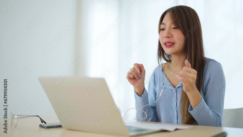 Young asian woman working at home. Female using computer laptop on desk at house Young asian woman working at home. Female using computer laptop on desk at house