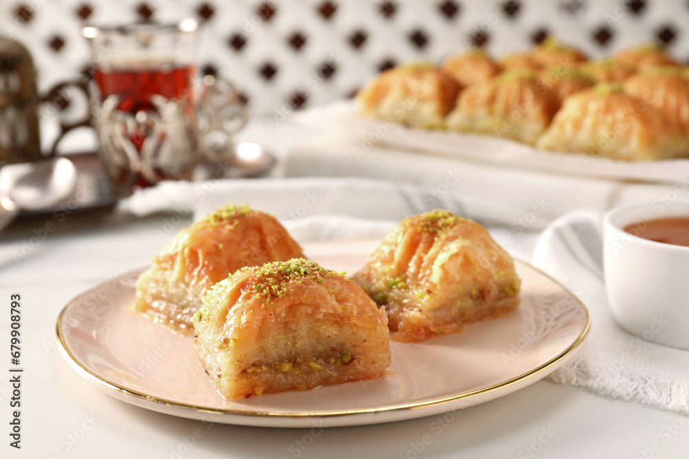 Delicious sweet baklava with pistachios on white table, closeup Delicious sweet baklava with pistachios on white table, closeup