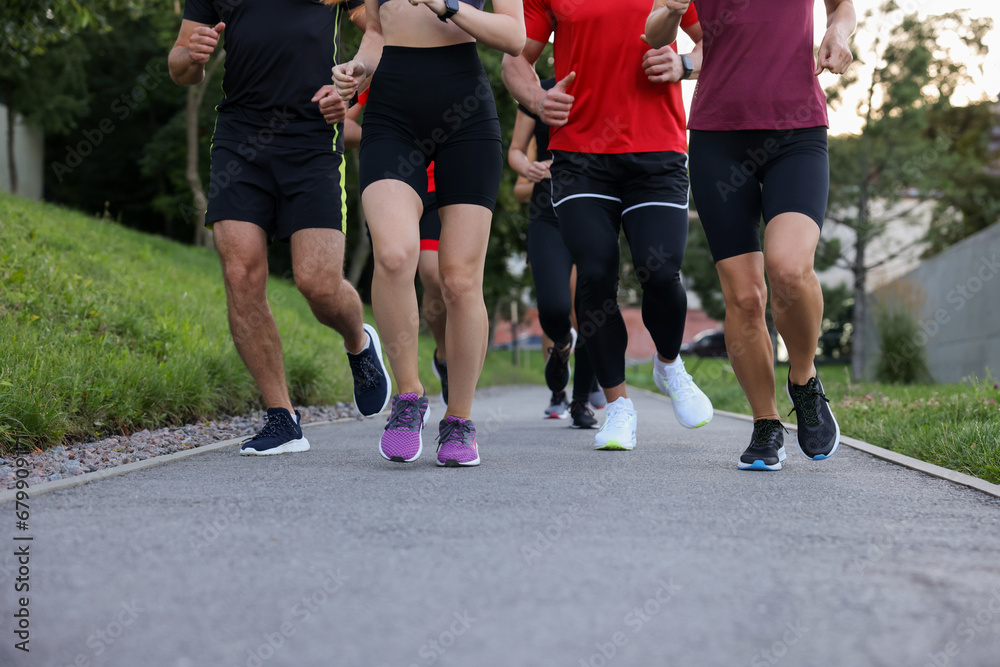 Group of people running outdoors, closeup view Group of people running outdoors, closeup view