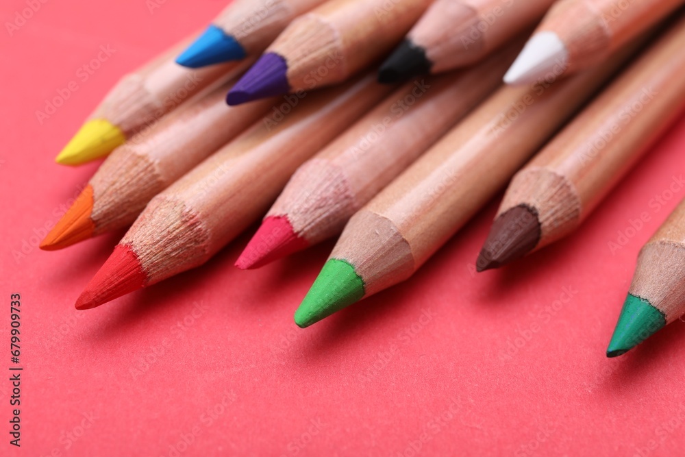 Many colorful pastel pencils on red background, closeup. Drawing supplies Many colorful pastel pencils on red background, closeup. Drawing supplies