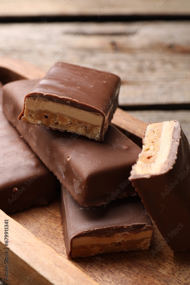 Tasty chocolate bars with nougat on table, closeup
