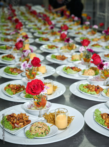 food being plated at a wedding. this image has a very shallow depth of field