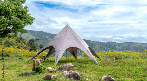 Camping tent with beautiful mountain natural scenery of wildflower fields in Pleiku, Gia Lai province, Vietnam photo