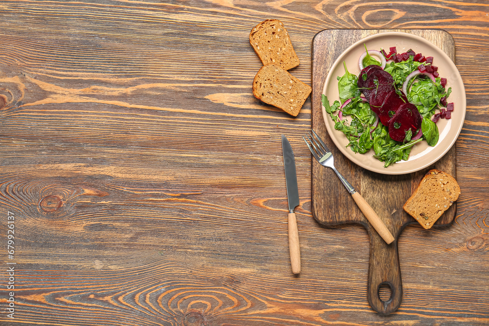 Plate of fresh vegetable salad with beet and bread on wooden background Plate of fresh vegetable salad with beet and bread on wooden background