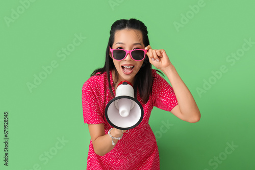 Young Asian woman with mega...