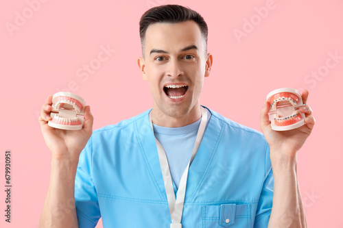 Male dentist holding jaw mo...