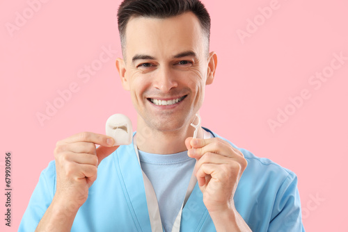 Male dentist with floss and...