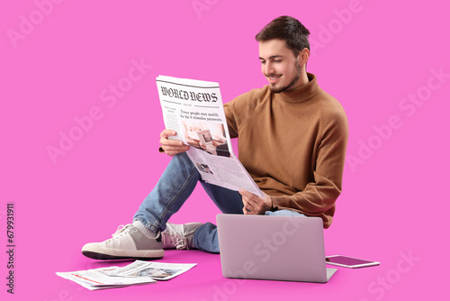 Young man with newspaper an...