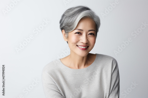 Beautiful grey hair asian woman smiling with smooth face skin.