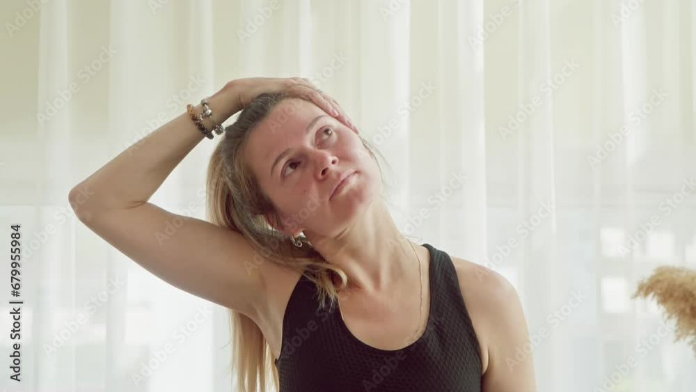 Portrait middle aged woman practicing yoga exercise bending neck with hand home in lotus pose. Sport, fitness, training, stretching, workout, wellness body care concept. Mature female doing gymnastic. Portrait middle aged woman practicing yoga exercise bending neck with hand home in lotus pose. Sport, fitness, training, stretching, workout, wellness body care concept. Mature female doing gymnastic.