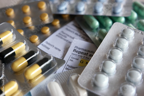 Medical Prescription covered with a bunch of different pills showing the state of healthcare of today.