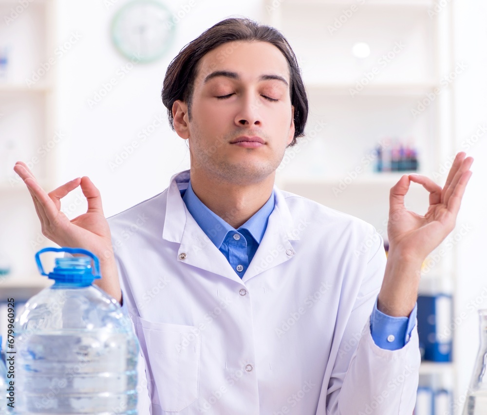 Young male chemist experimenting in lab Young male chemist experimenting in lab
