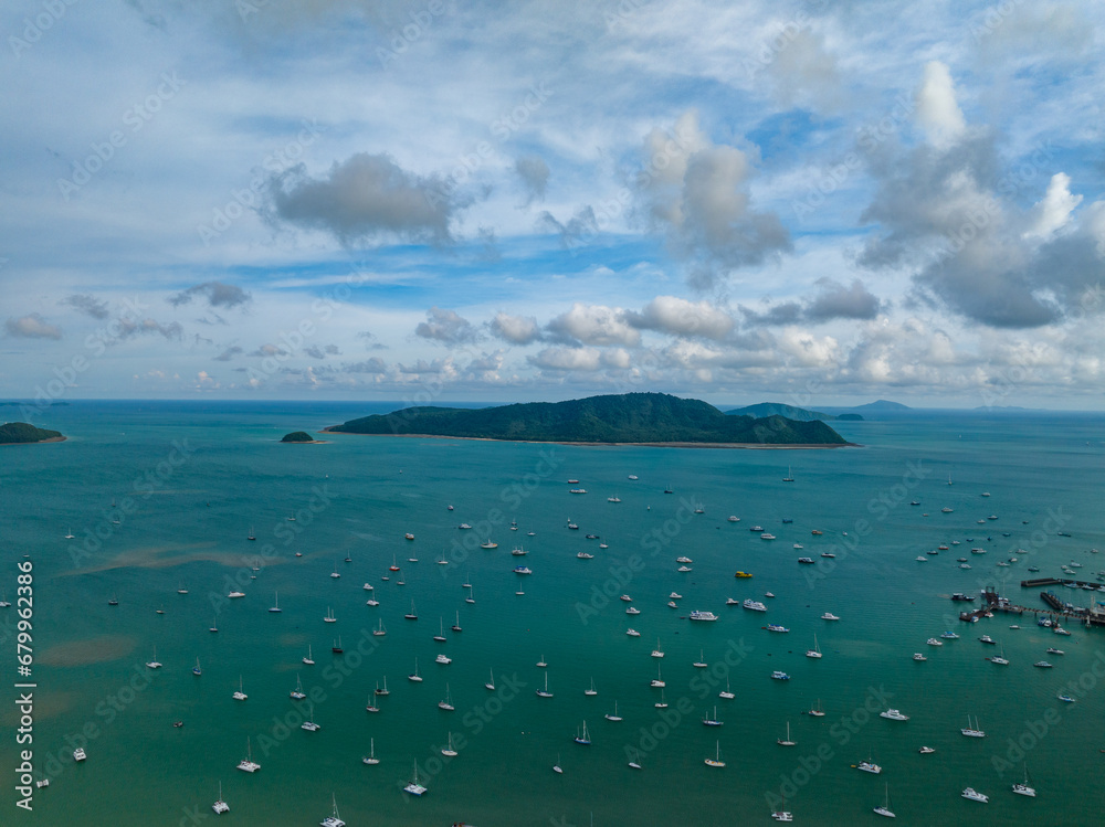 Aerial View Amazing sea with travel boats,sailing boats in the sea,Beautiful sea in summer season at Phuket island Thailand,Travel boats,Ocean during summer blue sky background