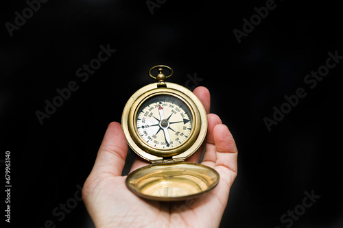hand holding a compass, concept for what direction to chose