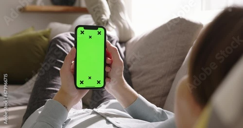 Unrecognizable girl holding smartphone with chromakey in hands. Advertising of phone applications: online shopping, ordering services, smart home control, calling taxi, calorie counting application