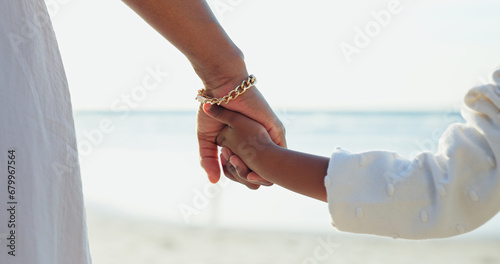 Woman, child or holding hands for love by beach or bonding together for happiness on summer vacation. Commitment, mother or kid in support relationship, holiday or relax wellness by calm ocean