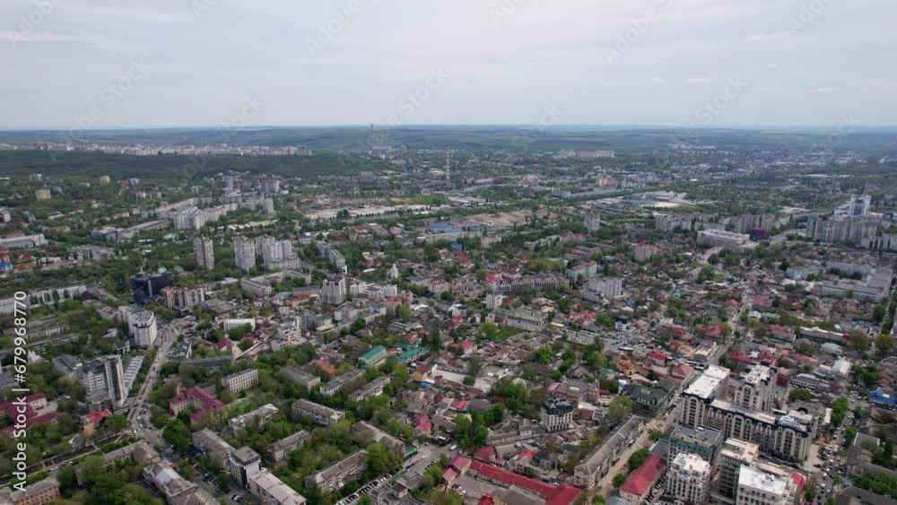 Aerial panoramic drone view of Chisinau in Moldova with roads, buildings, cars roofs of houses and spring trees in daylight. Chisinau, capital city of Republic of Moldova. 4K video. Aerial panoramic drone view of Chisinau in Moldova with roads, buildings, cars roofs of houses and spring trees in daylight. Chisinau, capital city of Republic of Moldova. 4K video.