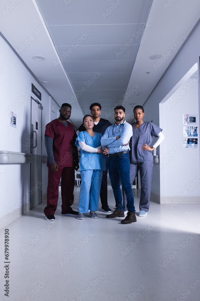 Fototapeta premium Portrait of diverse male and female doctors standing in hospital corridor
