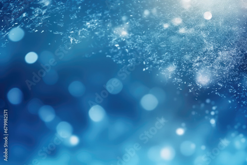 Winter snowy blurred defocused blue background with copy space. Flakes of snow fall. Festive Christmas and New year background