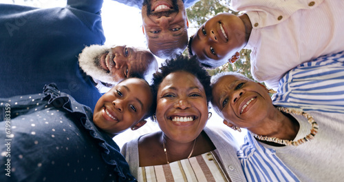 Happy, huddle or portrait of a black family in nature for fun bonding or playing in a park together. Smile, support or below of mother with grandparents, father or children to hug or relax on holiday © Charlize D/peopleimages.com