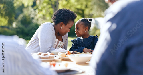 Smile, mother or daughter with lunch in garden, food or nature relax for vacation together with love. Black people, woman or child as happy family, reunion and care bonding for brunch table in park