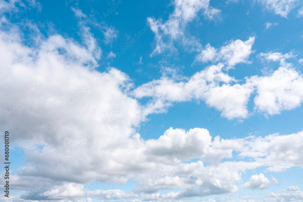 white cirrus, feathery clouds against spring bright blue cloudy sky on sunny day in England white cirrus, feathery clouds against spring bright blue cloudy sky on sunny day in England