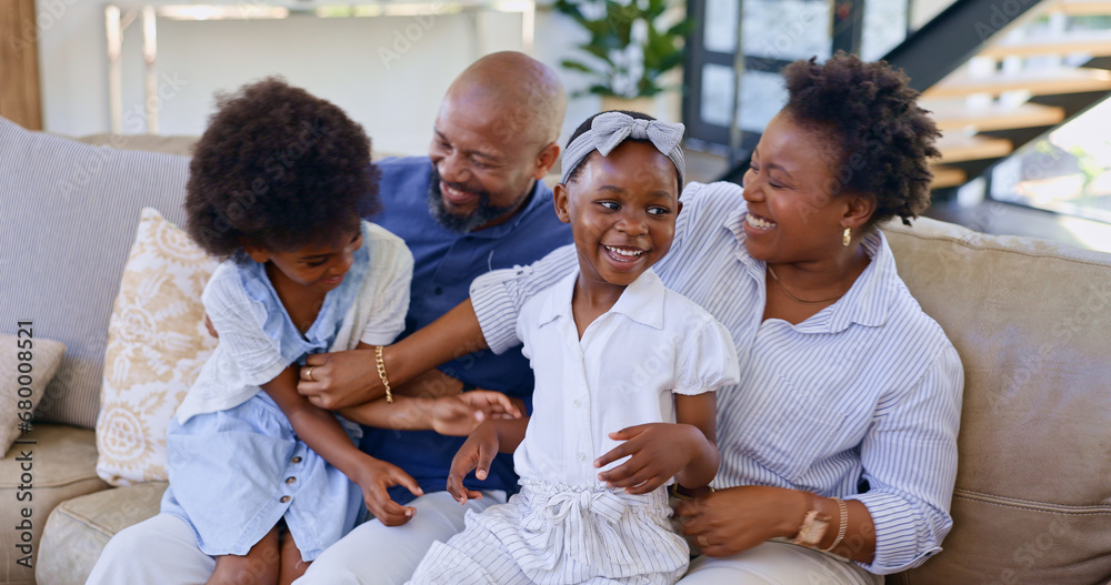 Happy black family, relax and playing on sofa in living room for bonding, holiday or weekend together at home. African mother, father and children smile for fun break, support or love at house Happy black family, relax and playing on sofa in living room for bonding, holiday or weekend together at home. African mother, father and children smile for fun break, support or love at house