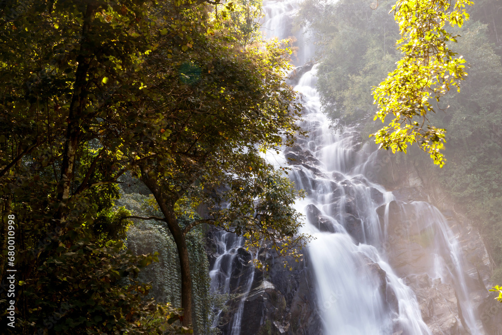 Fototapeta premium Mae Tia waterfall beauty of the streams flows gently waterfall in Orb Luang national park, Chom Thong, Chiang Mai, Thailand. Travel point for camping with sound of a flowing nature.