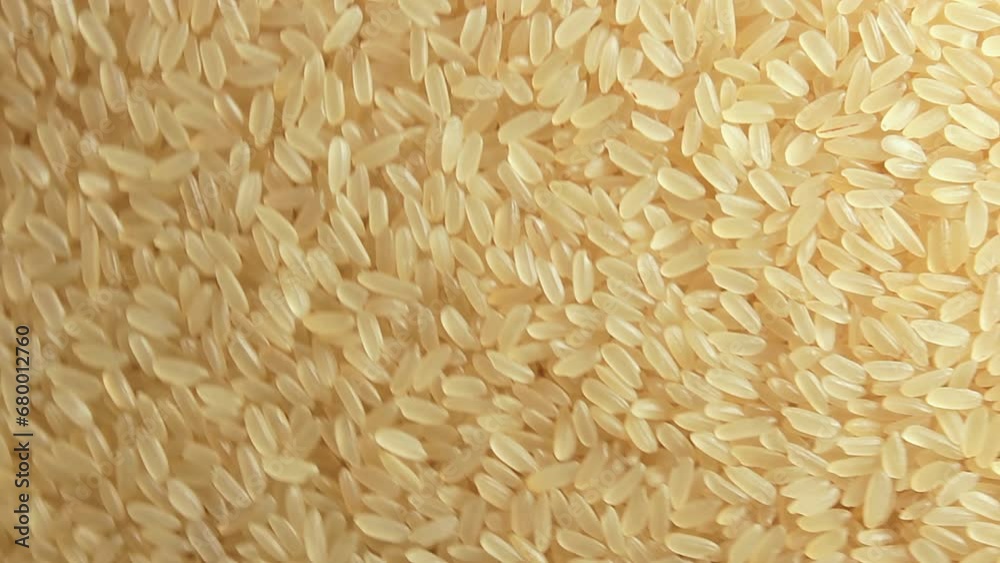 Dry Uncooked Parboiled Rice Background Rotating Clockwise - Top View. Scattered Raw Long Grain Rice. Asian Cuisine and Culture. Healthy Eating Ingredients. Diet Food. Angular Rotation Right Dry Uncooked Parboiled Rice Background Rotating Clockwise - Top View. Scattered Raw Long Grain Rice. Asian Cuisine and Culture. Healthy Eating Ingredients. Diet Food. Angular Rotation Right