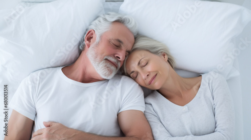caucasian senior couple sleeping relaxed together in a bed	