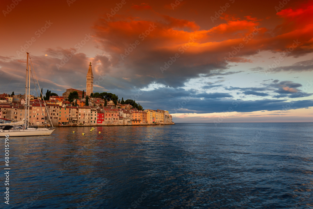 Wonderful morning view of old  Rovinj town with multicolored buildings and yachts moored along embankment, Croatia.
