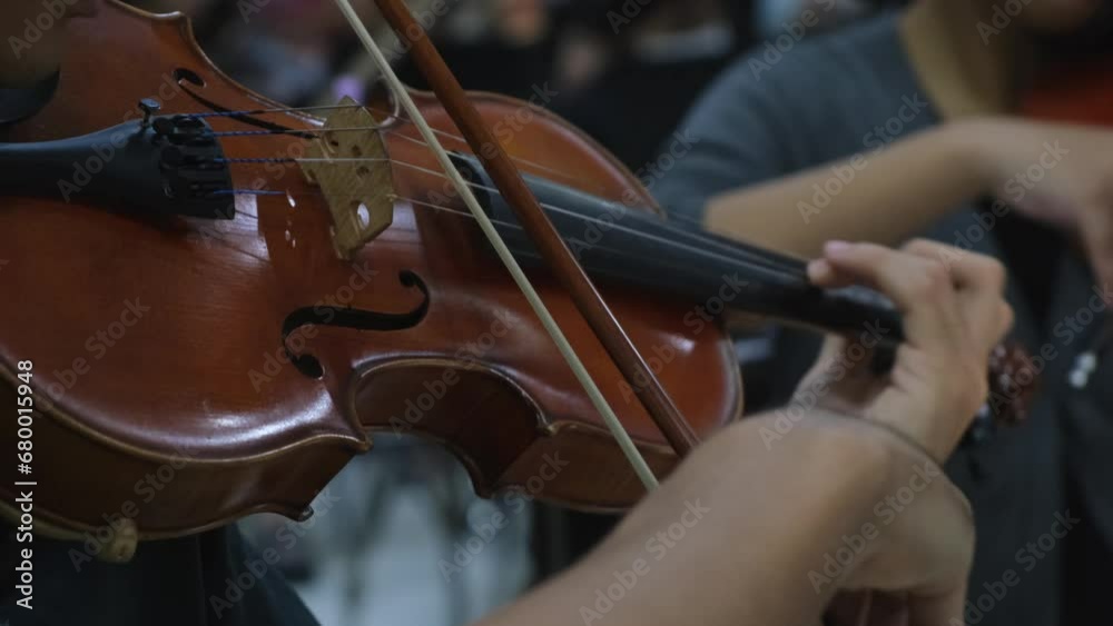 Violin Player plays a certain music, left-hand fingers attack the notes with vibrato as the right-hand bows the notes together with others performers. Violin Player plays a certain music, left-hand fingers attack the notes with vibrato as the right-hand bows the notes together with others performers.