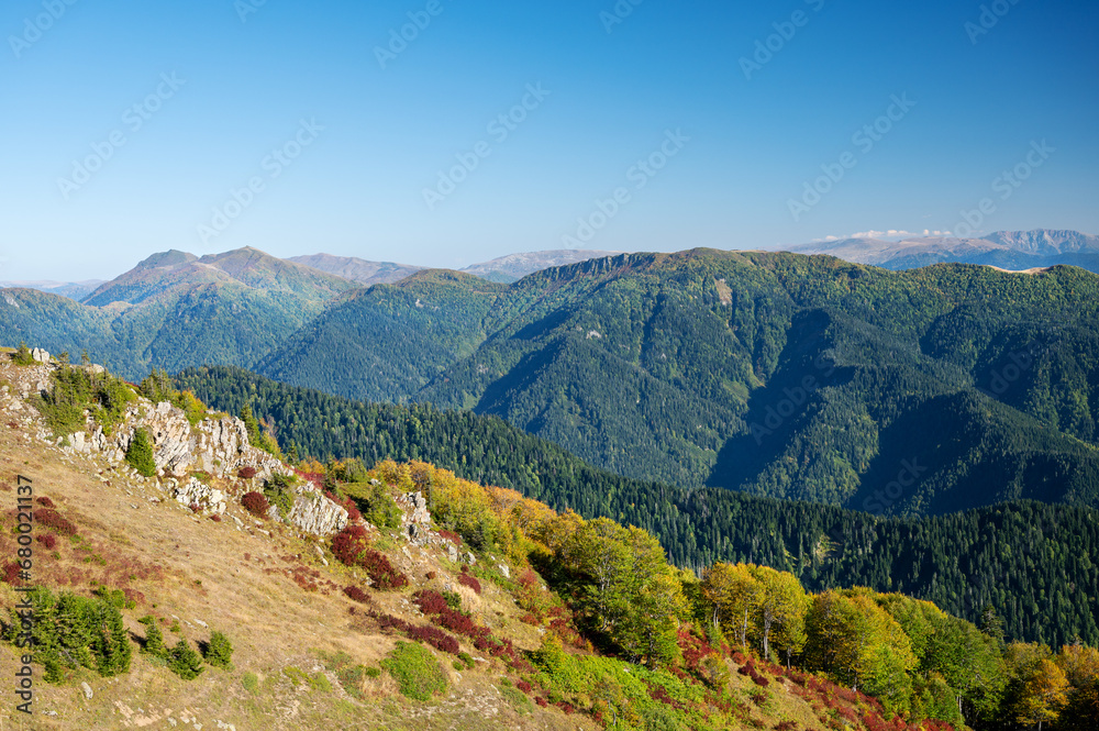 Beautiful autumn mountain landscape with colorful trees. Traveling through the mountains of Georgia.